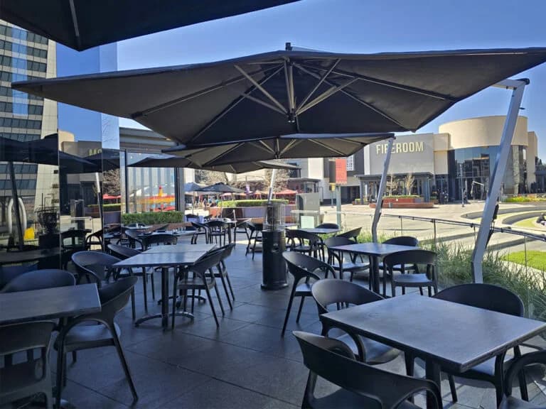 Umbrellas shading a commercial outdoor dining setting