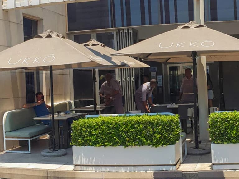 Standard 8.5 ft Square Center-Pole Umbrella in an installed outdoor setting